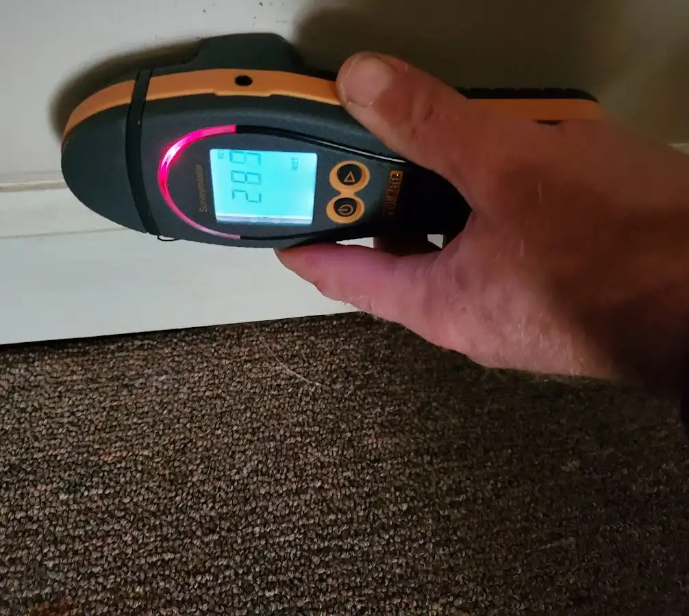 Moisture detection at baseboard during Storm Damage Restoration in West Lampeter